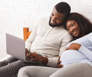 Expectant couple watching class on laptop